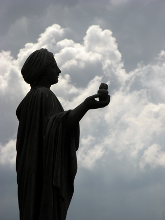 Statue against puffy clouds, Recoleta Cemetery